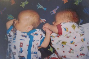 Babies holding hands